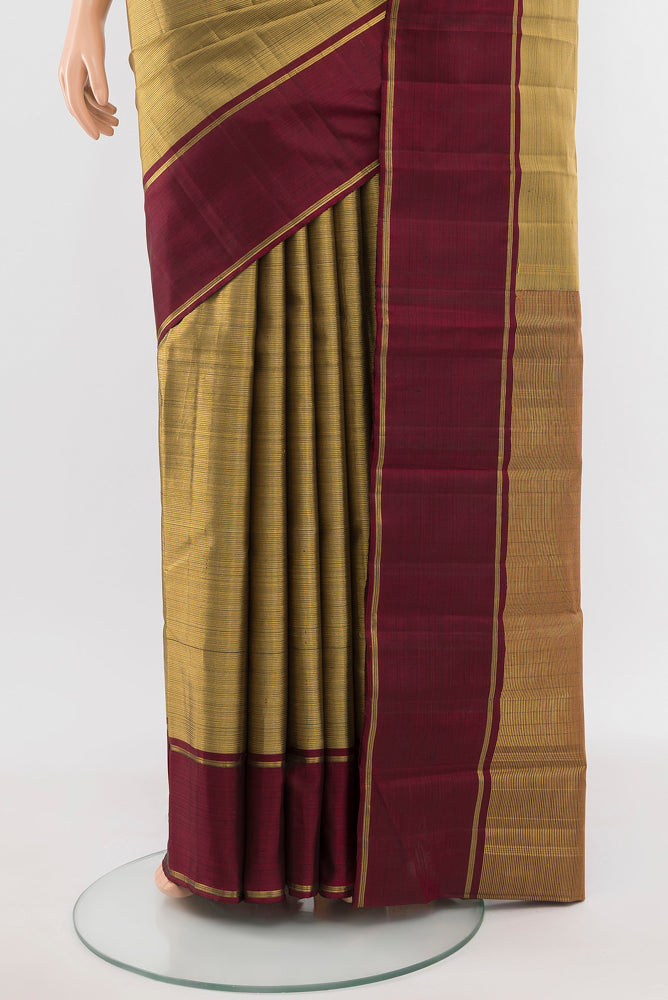 Pleats and pallu of Golden Kanjivaram Silk Saree with Zari Butta on the body and Silk Border. 