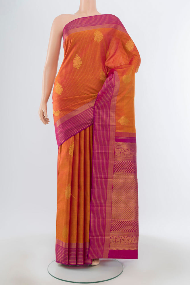 Pure Silk Pure Zari Peach Kanjivaram Saree with Zari Butta on the body and Silk Border.  displayed on a mannequin