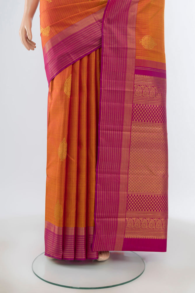 Pleats and pallu of Pure Silk Pure Zari Peach Kanjivaram Saree with Zari Butta on the body and Silk Border. 