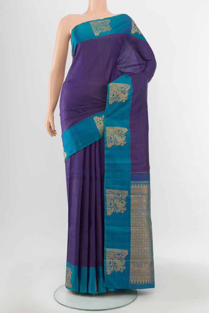 Pure Silk Pure Zari Violet Kanjivaram Saree with Zari Butta on the body and Silk Border.  displayed on a mannequin