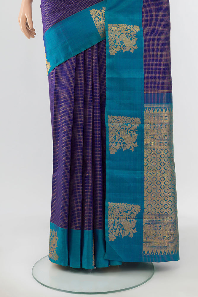 Pleats and pallu of Pure Silk Pure Zari Violet Kanjivaram Saree with Zari Butta on the body and Silk Border. 