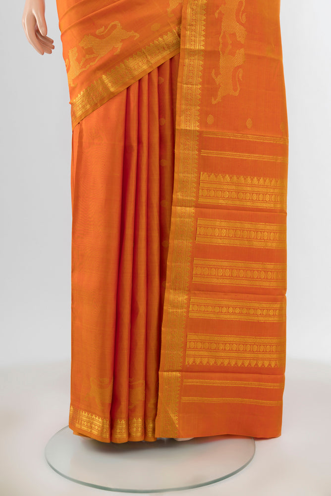 Pleats and pallu of Orange Kanjivaram Silk Saree with Zari Butta on the body and Silk Border. 