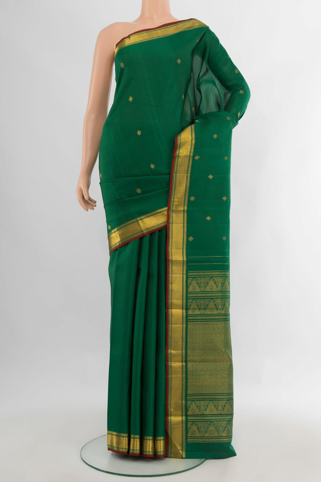 Pure Silk Green Kanjivaram Saree with Zari Butta on the body and Zari Border.  displayed on a mannequin