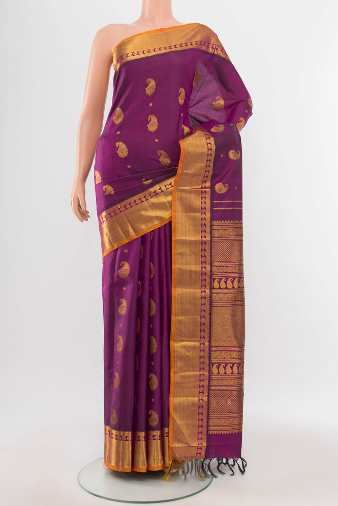 Purple Kanjivaram Silk Saree with Zari Butta on the body and Silk Border.  displayed on a mannequin