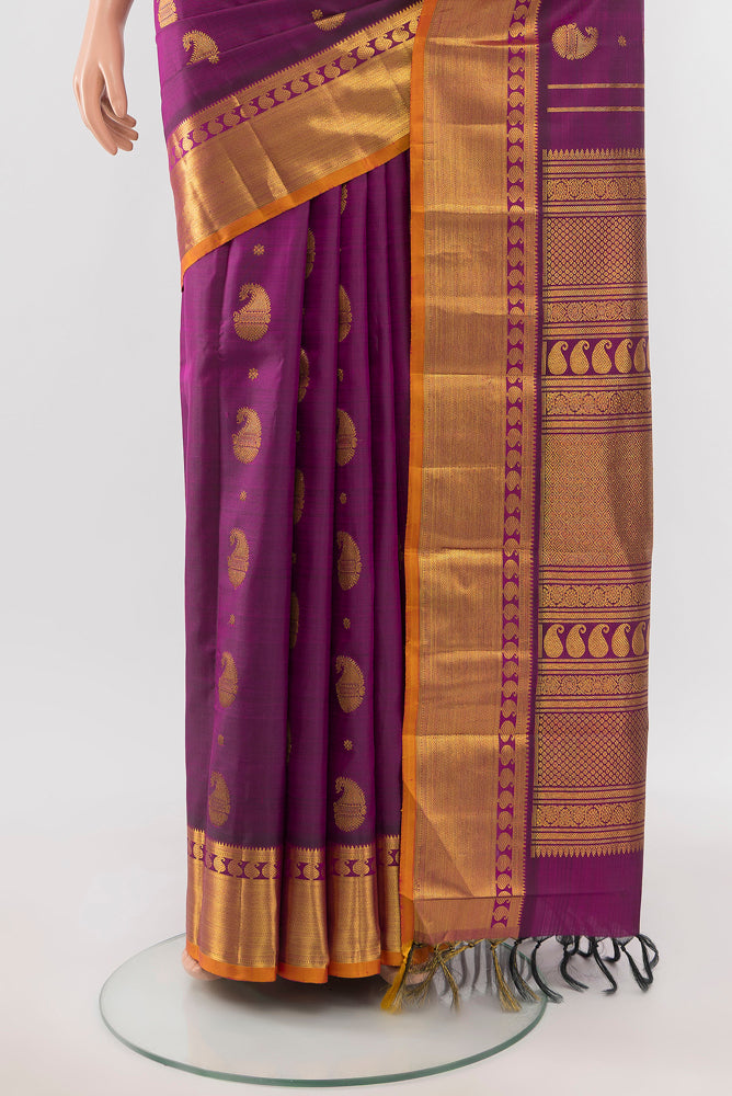 Pleats and pallu of Purple Kanjivaram Silk Saree with Zari Butta on the body and Silk Border. 
