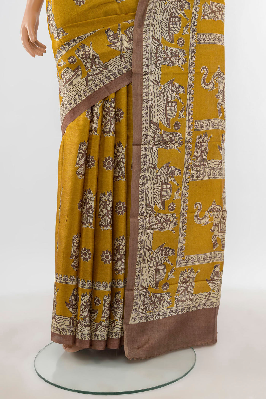 Pleats and pallu of Mustard Tussar Silk Saree with Printed design on the body and Printed Border. 