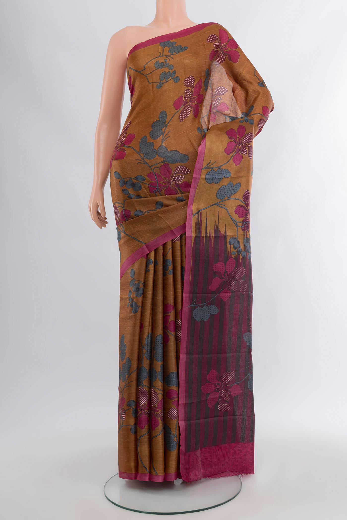 Brown Tussar Silk Saree with Floral Print on the body and Plain Border.  displayed on a mannequin