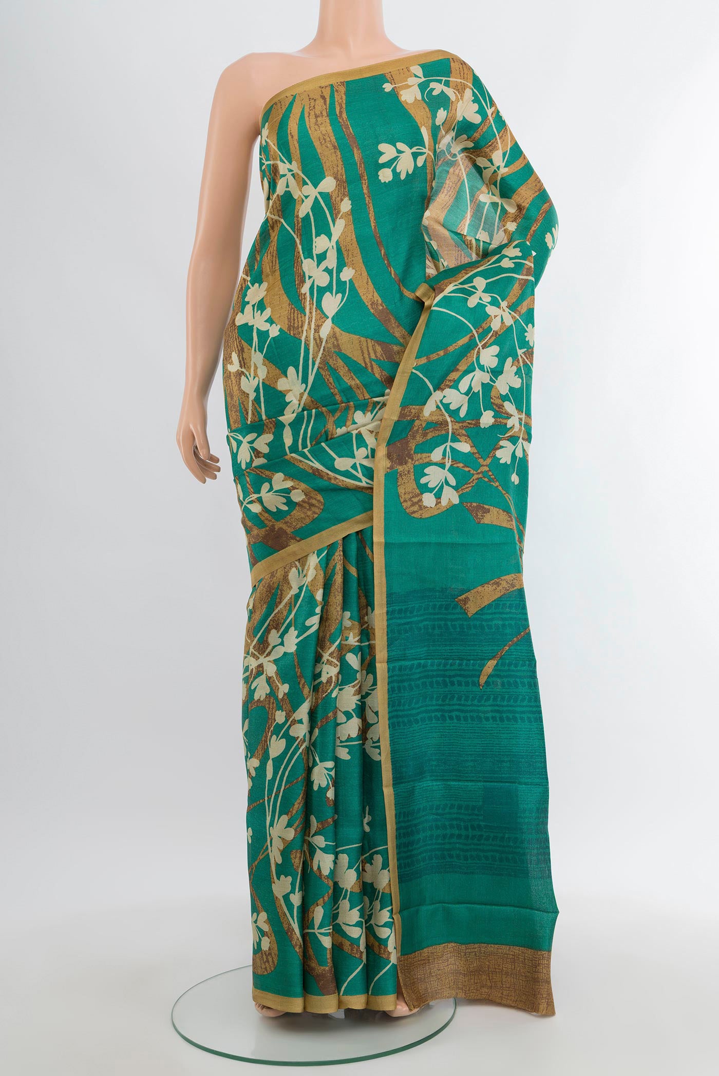 Green Tussar Silk Saree with Floral Print on the body and Plain Border.  displayed on a mannequin