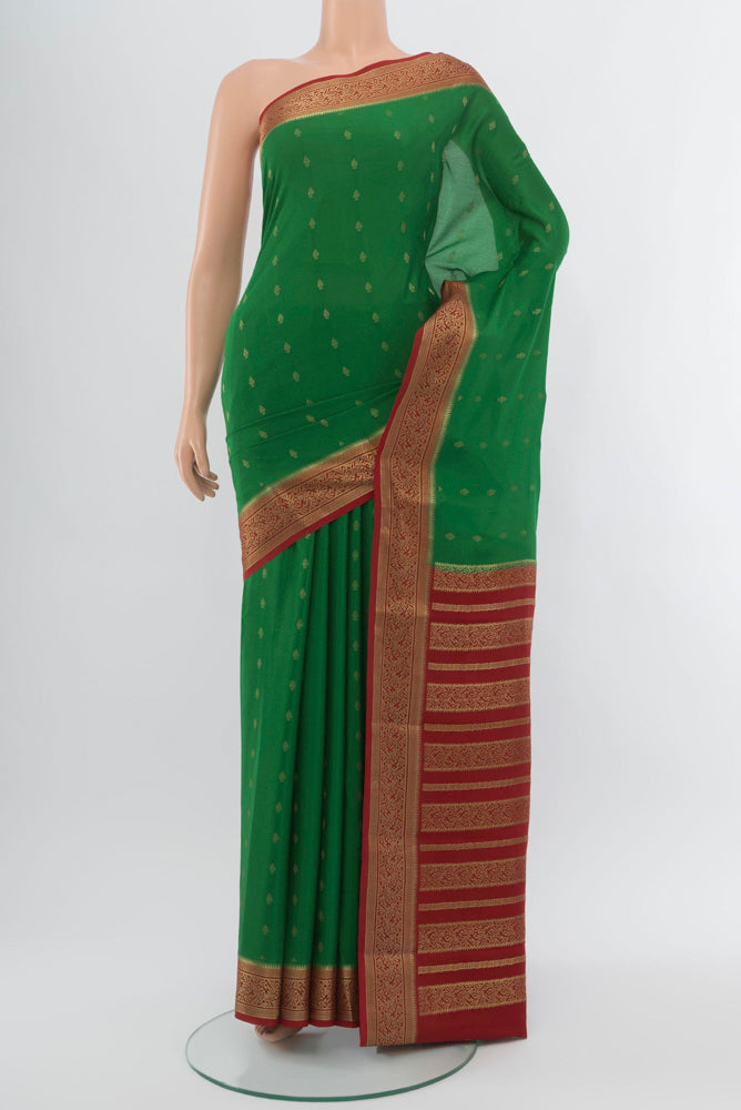 Mint Green Mysore Crepe Saree with Zari Butta on the body and Zari Border.  displayed on a mannequin