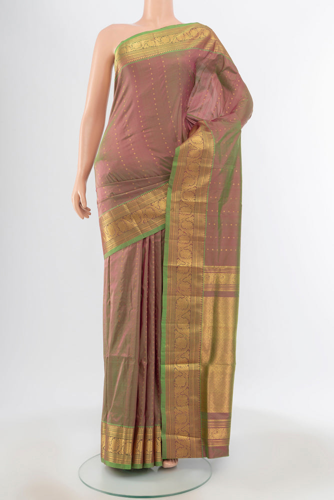 Light Green Kanjivaram Silk Saree with Zari Butta on the body and Silk Border.  displayed on a mannequin