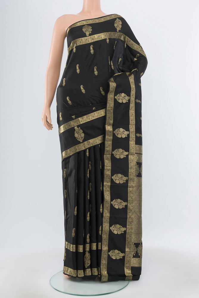 Pure Silk Pure Zari Black Kanchipuram Saree with Zari Butta on the body and Silk Border.  displayed on a mannequin