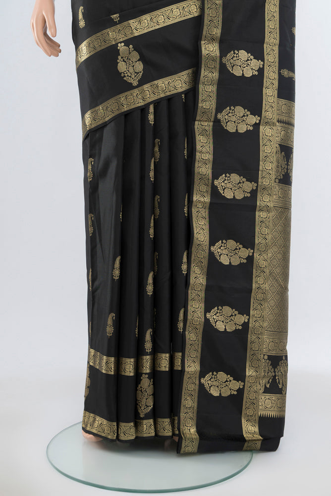 Pleats and pallu of Pure Silk Pure Zari Black Kanchipuram Saree with Zari Butta on the body and Silk Border. 