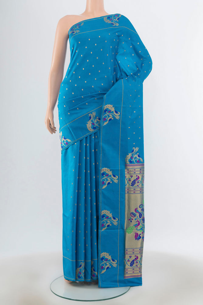 Light Blue Soft Silk Saree with Zari Butta on the body and Silk Border.  displayed on a mannequin