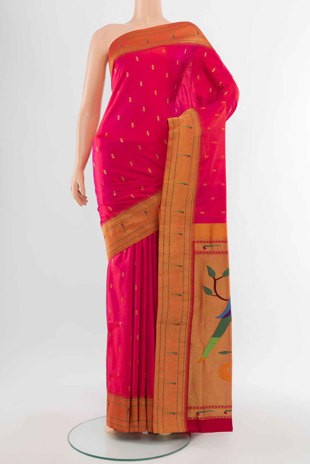 Golden Peach Soft Silk Saree with Zari Butta on the body and Silk Border.  displayed on a mannequin