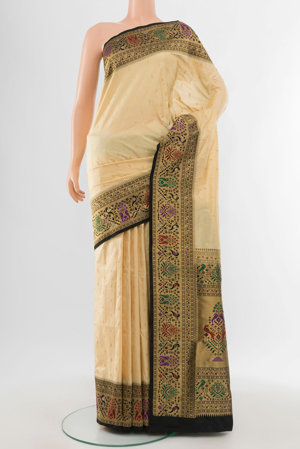 Cream Soft Silk Saree with Zari Butta on the body and Silk Border.  displayed on a mannequin