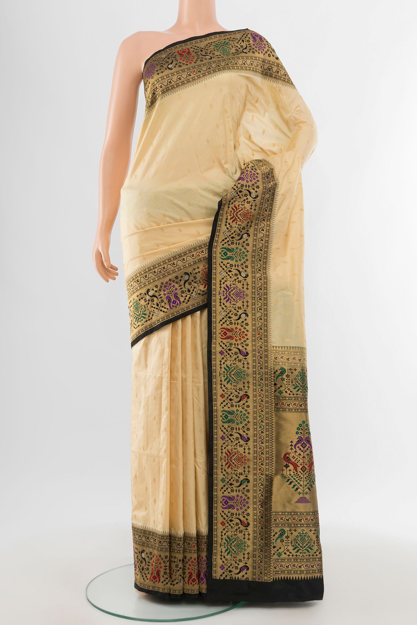 Cream Soft Silk Saree with Zari Butta on the body and Silk Border.  displayed on a mannequin