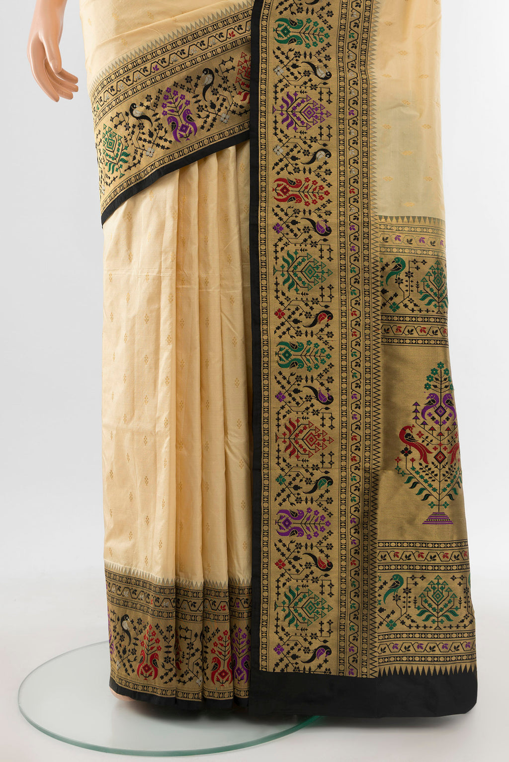 Pleats and pallu of Cream Soft Silk Saree with Zari Butta on the body and Silk Border. 