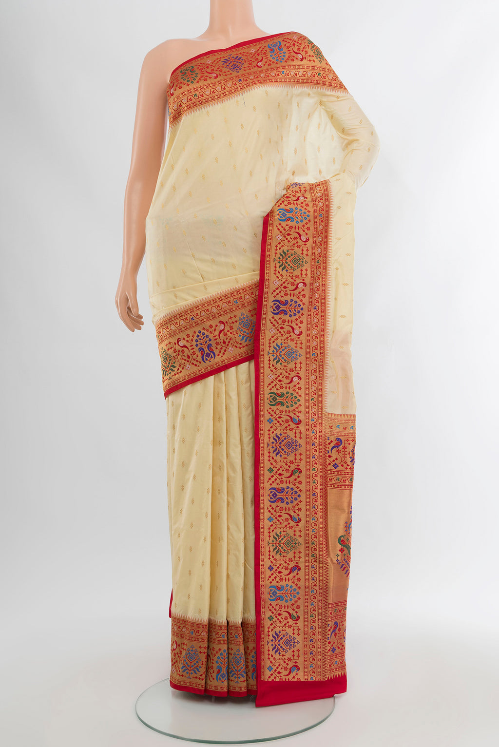 Cream Soft Silk Saree with Zari Butta on the body and Silk Border.  displayed on a mannequin