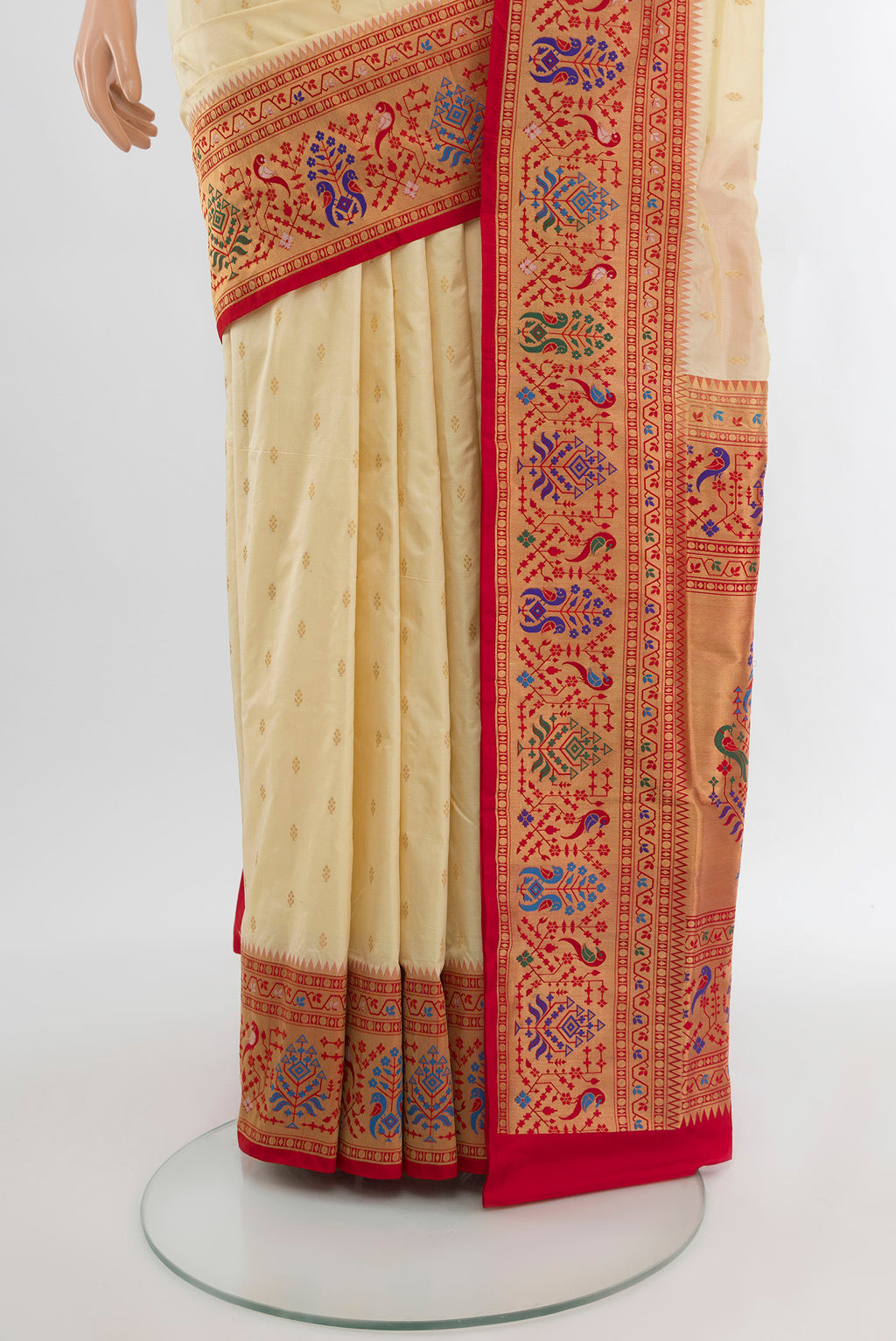 Pleats and pallu of Cream Soft Silk Saree with Zari Butta on the body and Silk Border. 