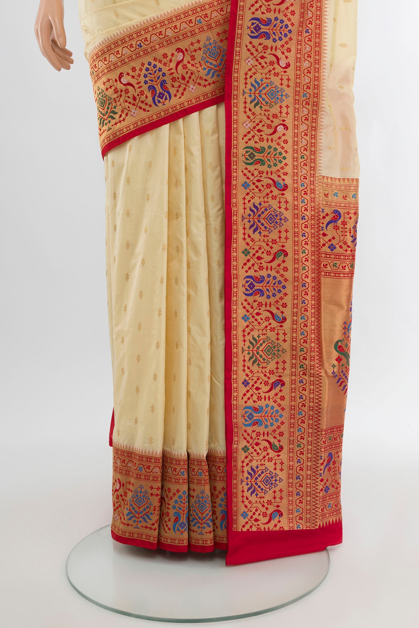 Pleats and pallu of Cream Soft Silk Saree with Zari Butta on the body and Silk Border. 