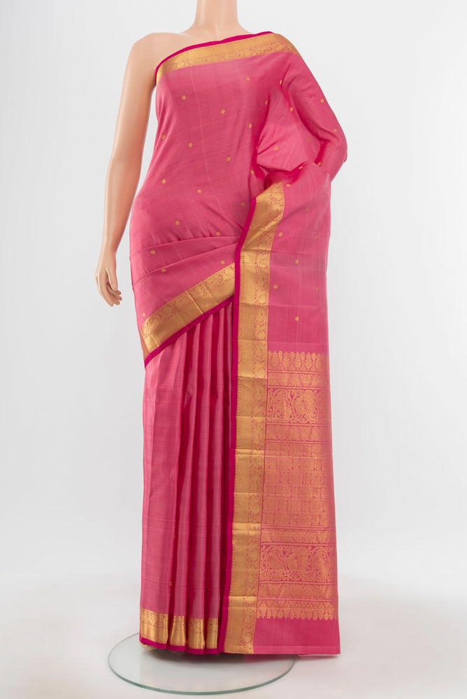 Pure Silk Pure Zari Peach Kanjivaram Saree with Zari Butta on the body and Silk Border.  displayed on a mannequin