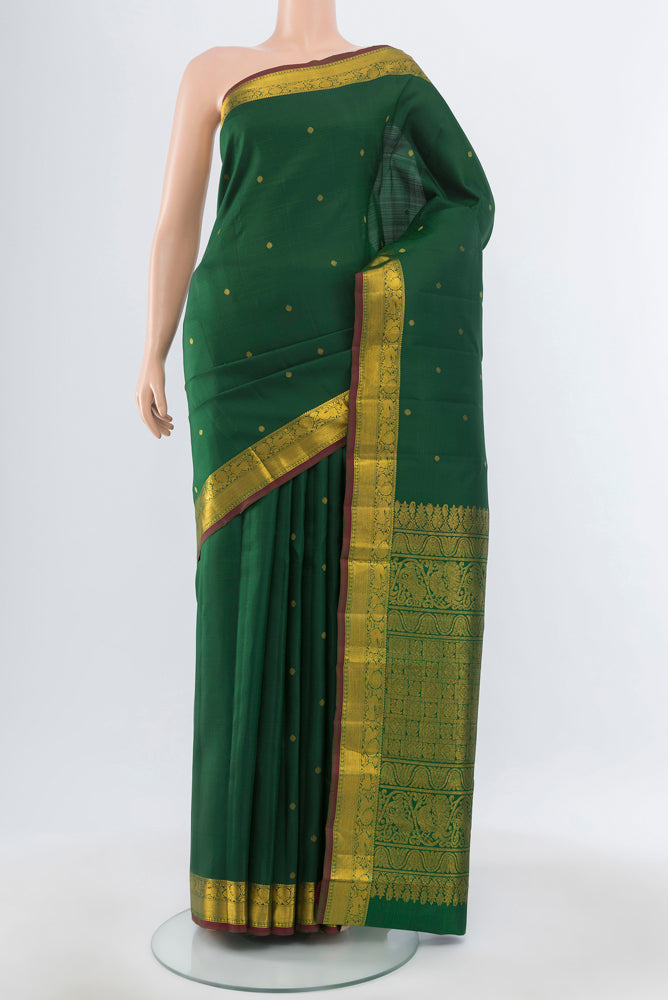 Pure Silk Pure Zari Green Kanjivaram Saree with Zari Butta on the body and Silk Border.  displayed on a mannequin