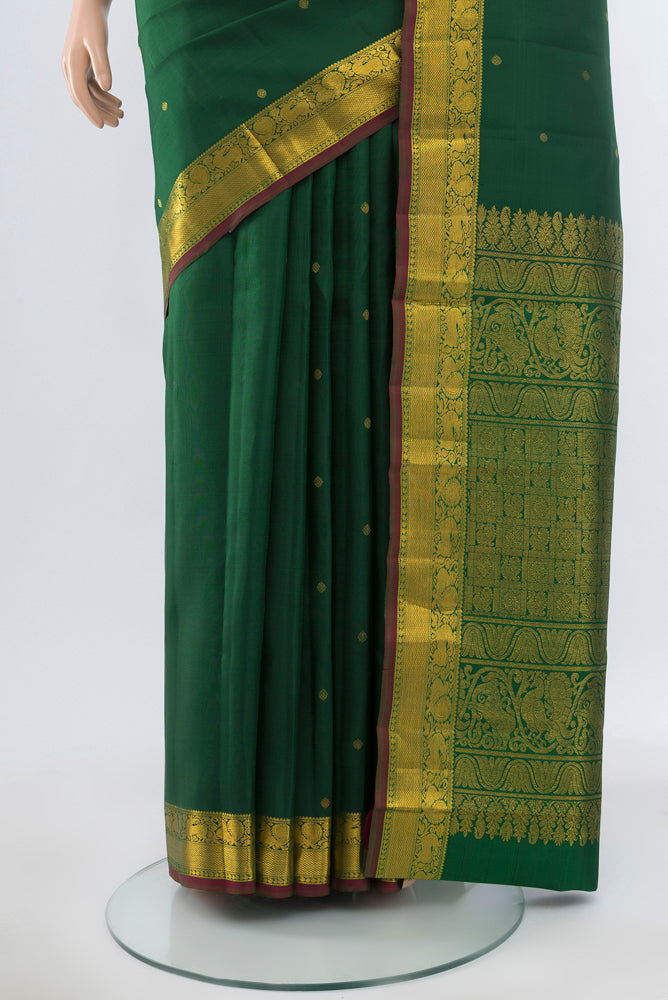 Pleats and pallu of Pure Silk Pure Zari Green Kanjivaram Saree with Zari Butta on the body and Silk Border. 