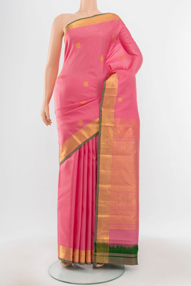 Pure Silk Pure Zari Peach Kanjivaram Saree with Zari Butta on the body and Silk Border.  displayed on a mannequin