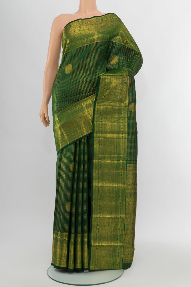 Mint Green Kanjivaram Silk Saree with Zari Butta on the body and Silk Border.  displayed on a mannequin