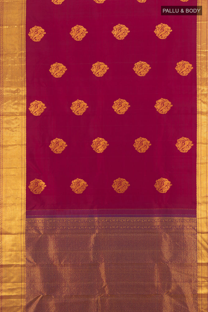 Flat view of Pure Silk Pure Zari Maroon Kanjivaram Saree with Zari Butta on the body and Silk Border. 