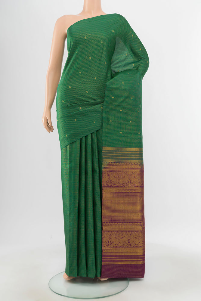 Pure Silk Pure Zari Bottle Green Kanjivaram Saree with Zari Butta on the body and Silk Border.  displayed on a mannequin