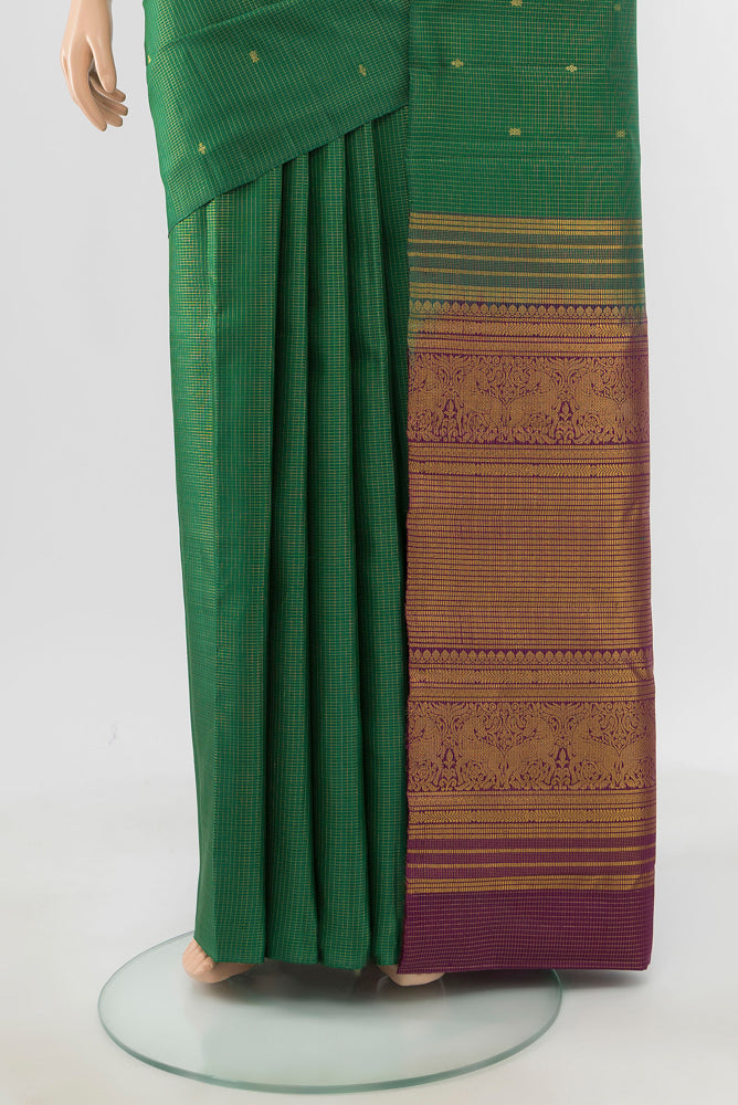 Pleats and pallu of Pure Silk Pure Zari Bottle Green Kanjivaram Saree with Zari Butta on the body and Silk Border. 