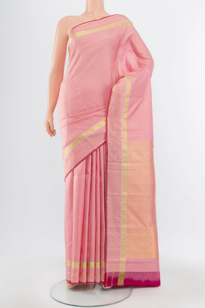 Pure Silk Pure Zari Rose Gold Kanjivaram Saree with Zari Brocade on the body and Silk Border.  displayed on a mannequin