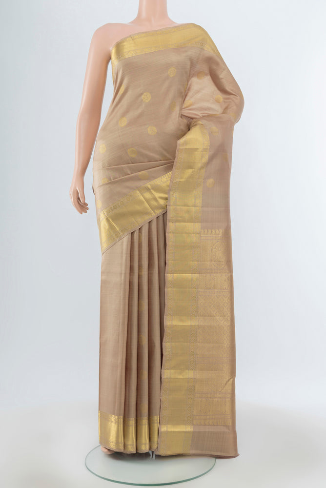 Dark Beige Kanjivaram Silk Saree with Zari Butta on the body and Silk Border.  displayed on a mannequin
