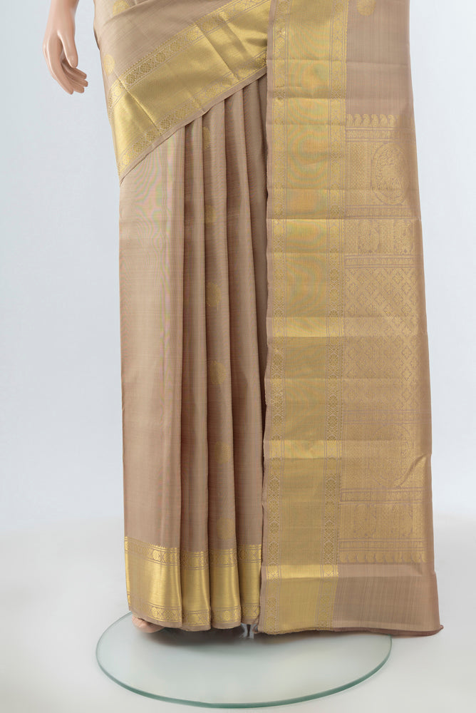 Pleats and pallu of Dark Beige Kanjivaram Silk Saree with Zari Butta on the body and Silk Border. 