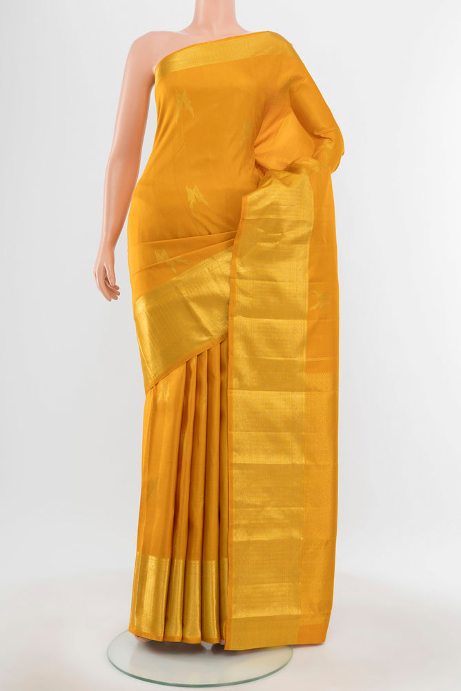Pure Silk Pure Zari Mustard Kanjivaram Saree with Zari Butta on the body and Silk Border.  displayed on a mannequin