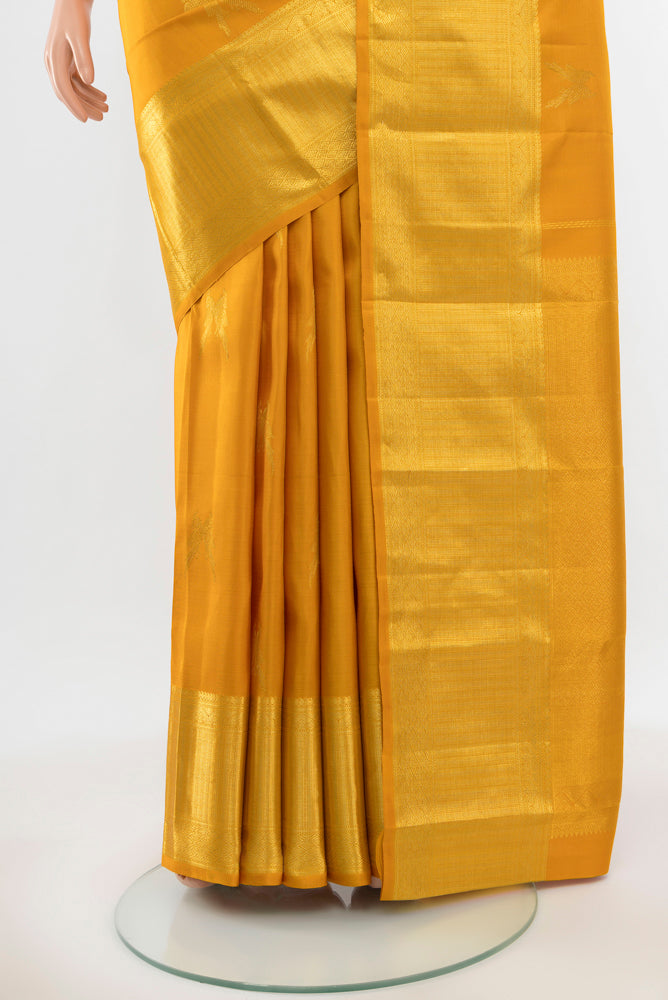 Pleats and pallu of Pure Silk Pure Zari Mustard Kanjivaram Saree with Zari Butta on the body and Silk Border. 