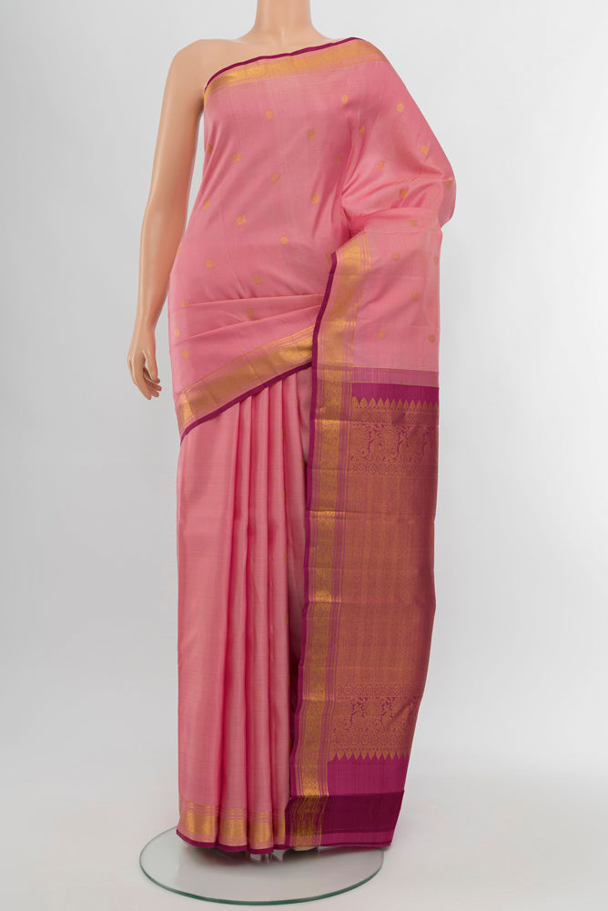 Rose Gold Kanjivaram Silk Saree with Zari Butta on the body and Silk Border.  displayed on a mannequin