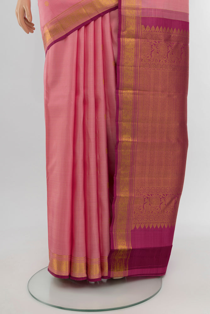 Pleats and pallu of Rose Gold Kanjivaram Silk Saree with Zari Butta on the body and Silk Border. 