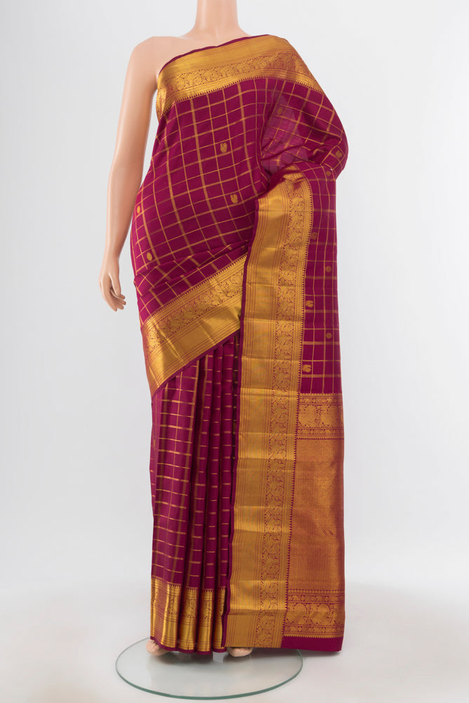 Pure Silk Pure Zari Maroon Kanjivaram Saree with Zari Butta on the body and Silk Border.  displayed on a mannequin