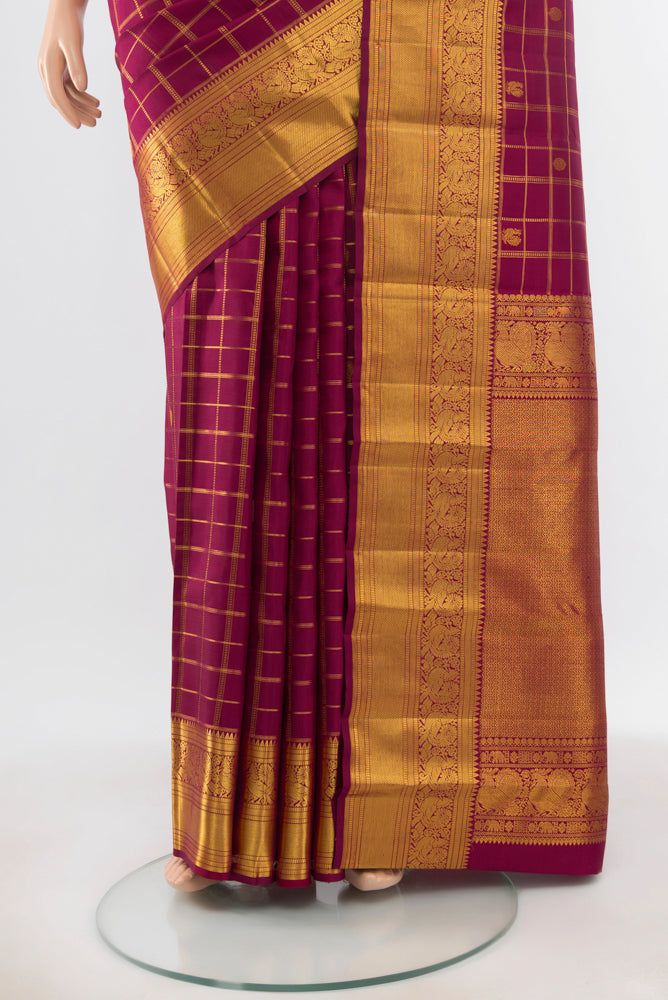Pleats and pallu of Pure Silk Pure Zari Maroon Kanjivaram Saree with Zari Butta on the body and Silk Border. 