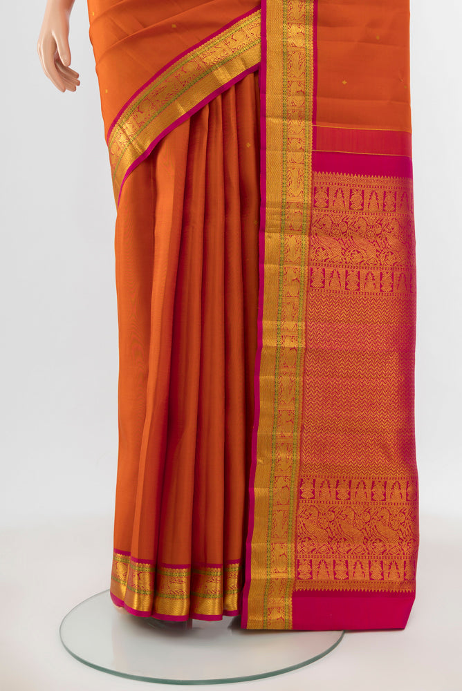 Pleats and pallu of Pure Silk Pure Zari Rust Kanjivaram Saree with Zari Butta on the body and Silk Border. 