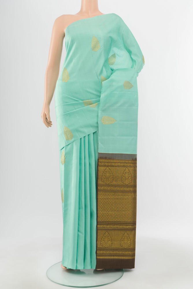Pure Silk Pure Zari Sky Blue Kanchipuram Saree with Zari Butta on the body and Silk Border.  displayed on a mannequin