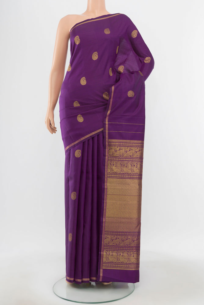 Pure Silk Pure Zari Violet Kanchipuram Saree with Zari Butta on the body and Silk Border.  displayed on a mannequin
