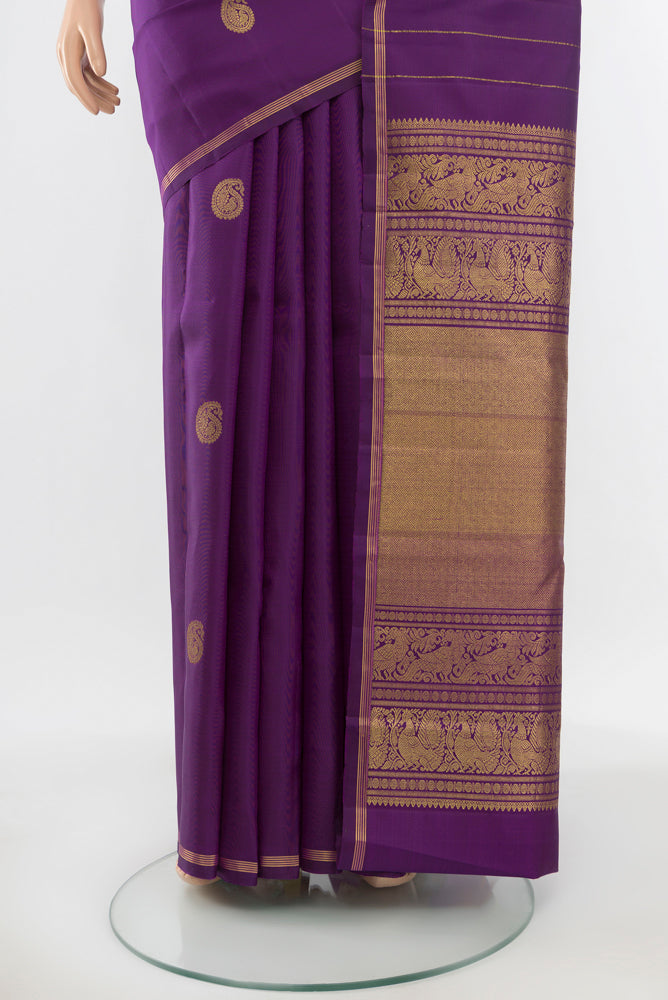 Pleats and pallu of Pure Silk Pure Zari Violet Kanchipuram Saree with Zari Butta on the body and Silk Border. 