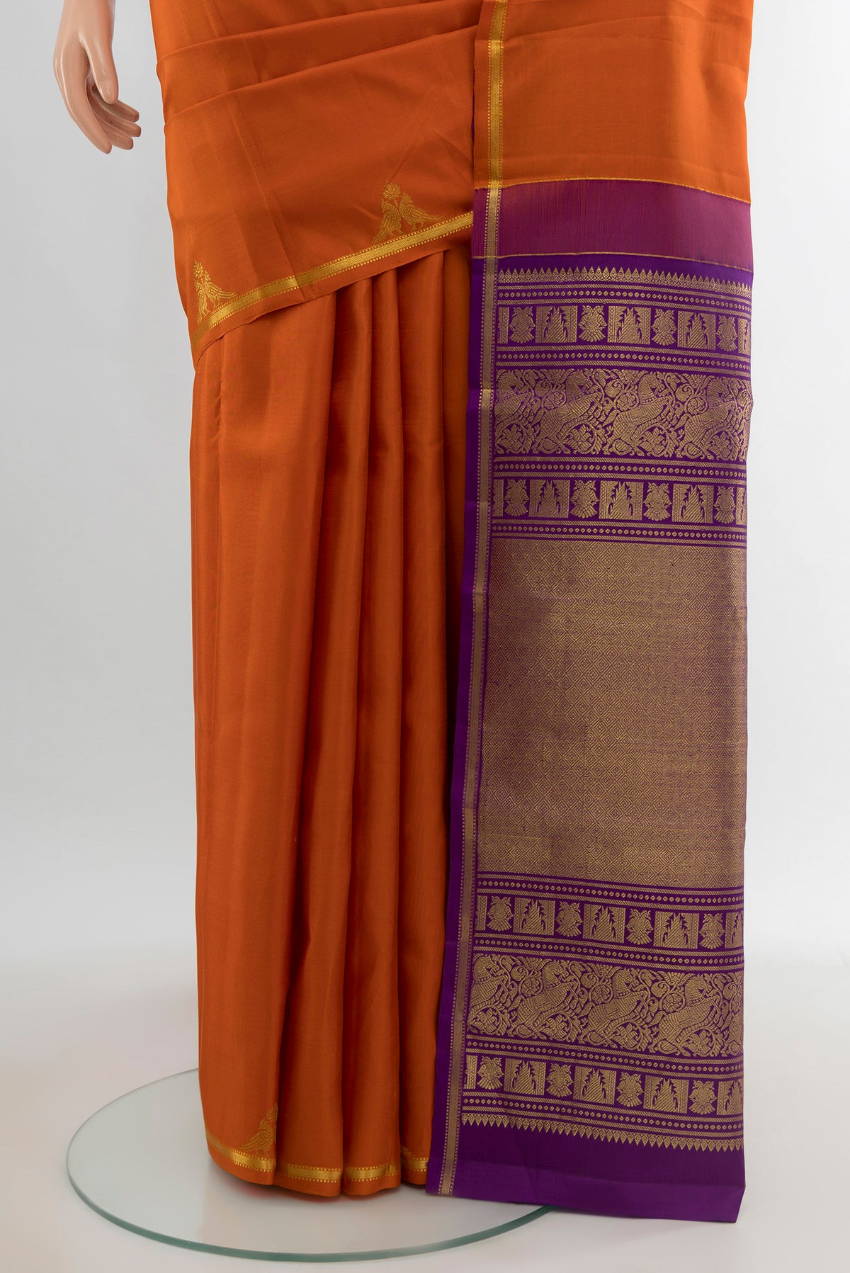 Pleats and pallu of Orange Kanchipuram Silk Saree with Zari Butta on the body and Zari Border. 