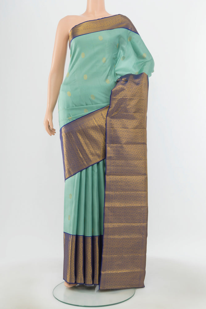 Pure Silk Pure Zari Teal Kanjivaram Saree with Zari Butta on the body and Silk Border.  displayed on a mannequin