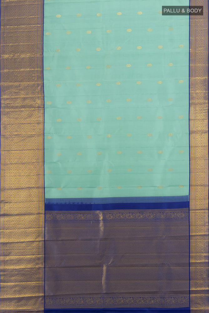 Flat view of Pure Silk Pure Zari Teal Kanjivaram Saree with Zari Butta on the body and Silk Border. 