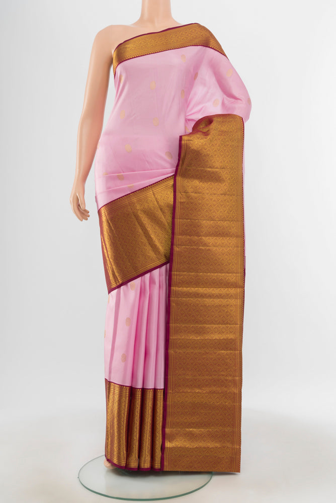 Pure Silk Pure Zari Rose Gold Kanjivaram Saree with Zari Butta on the body and Silk Border.  displayed on a mannequin