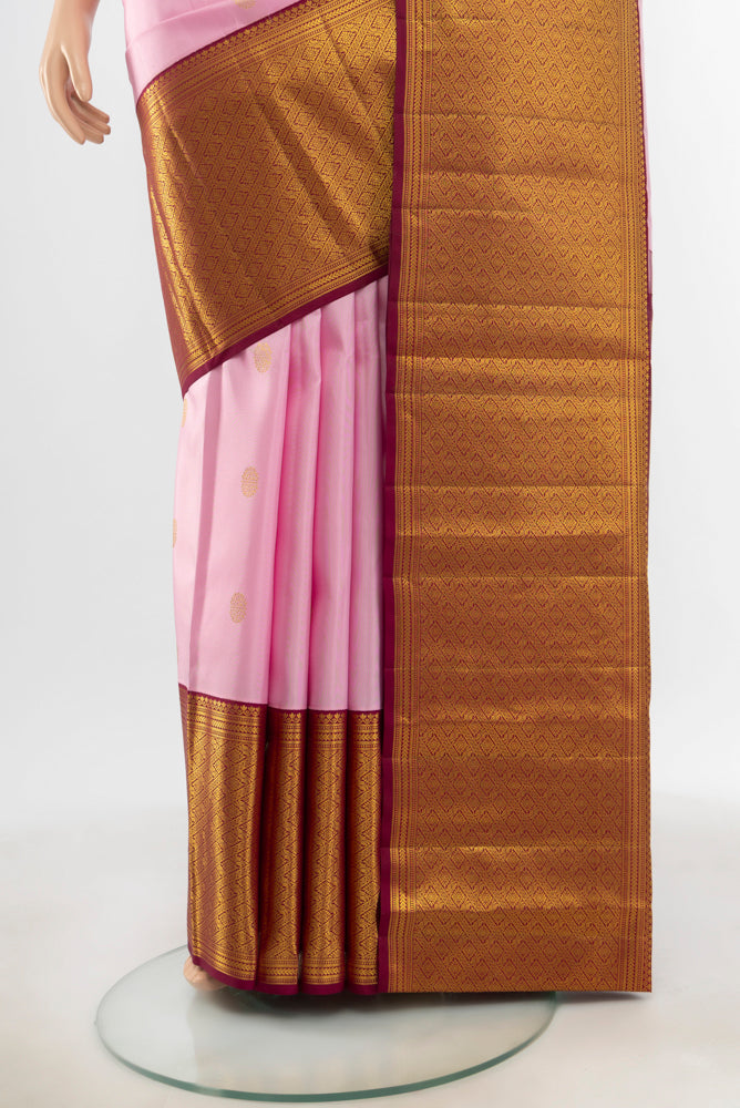 Pleats and pallu of Pure Silk Pure Zari Rose Gold Kanjivaram Saree with Zari Butta on the body and Silk Border. 